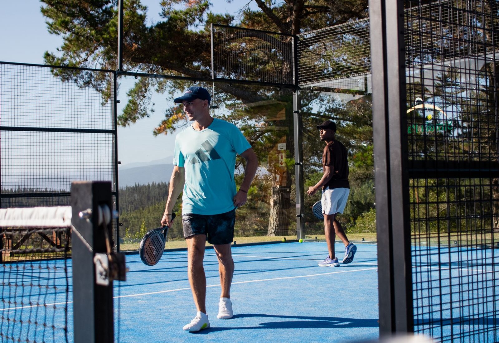 Padel players on an outdoor court, illustrative sport photography