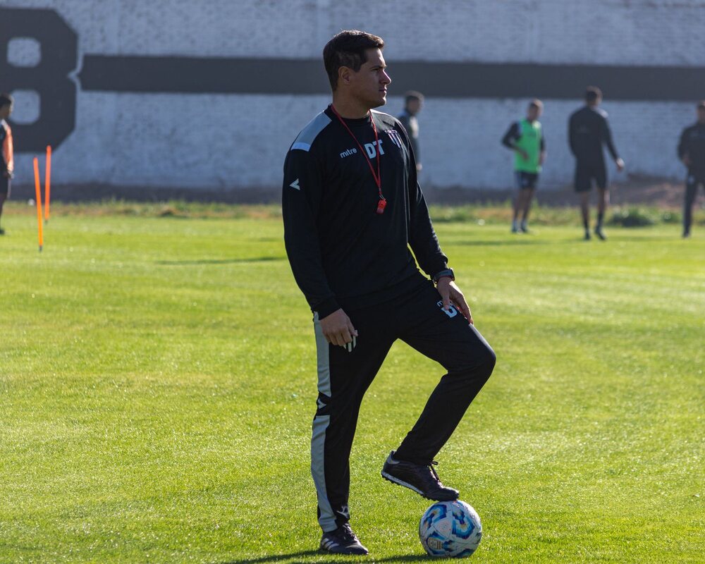 Football coach leading an outdoor practice