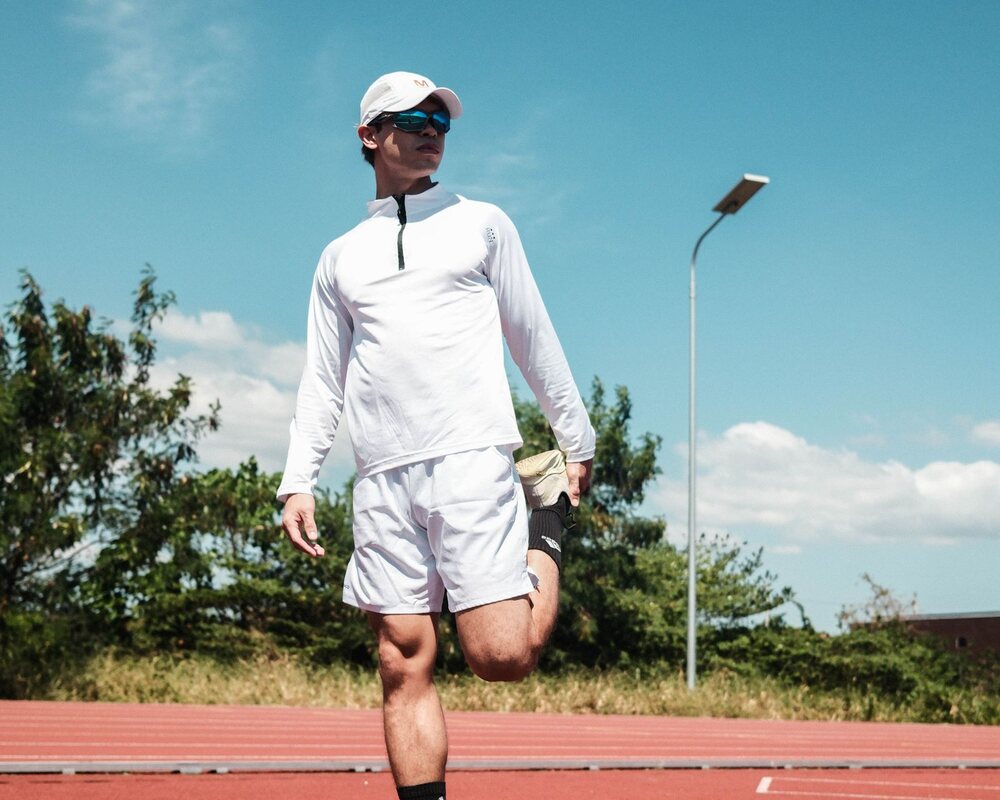 Athlete stretching on an outdoor running track