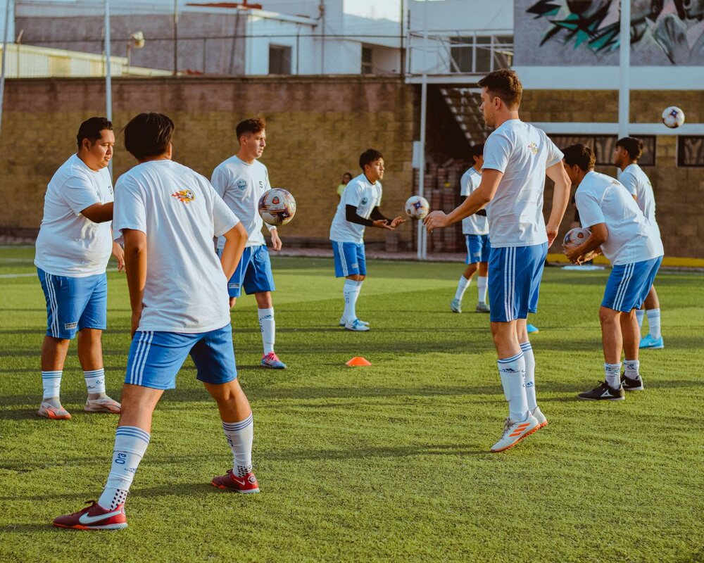 Youth football players practising together